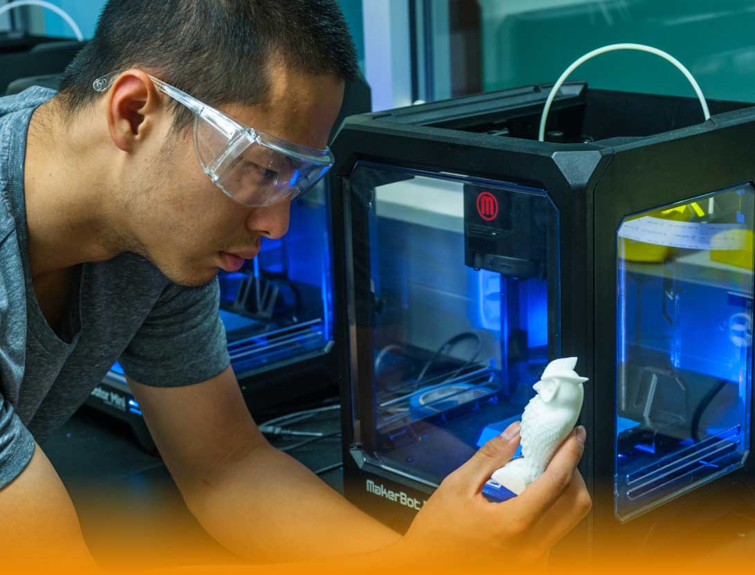 male student works with 3D printer