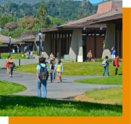 students walking by large building