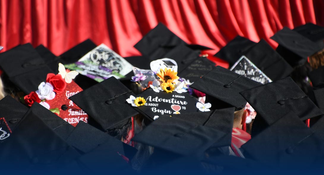 graduates wearing decorated caps